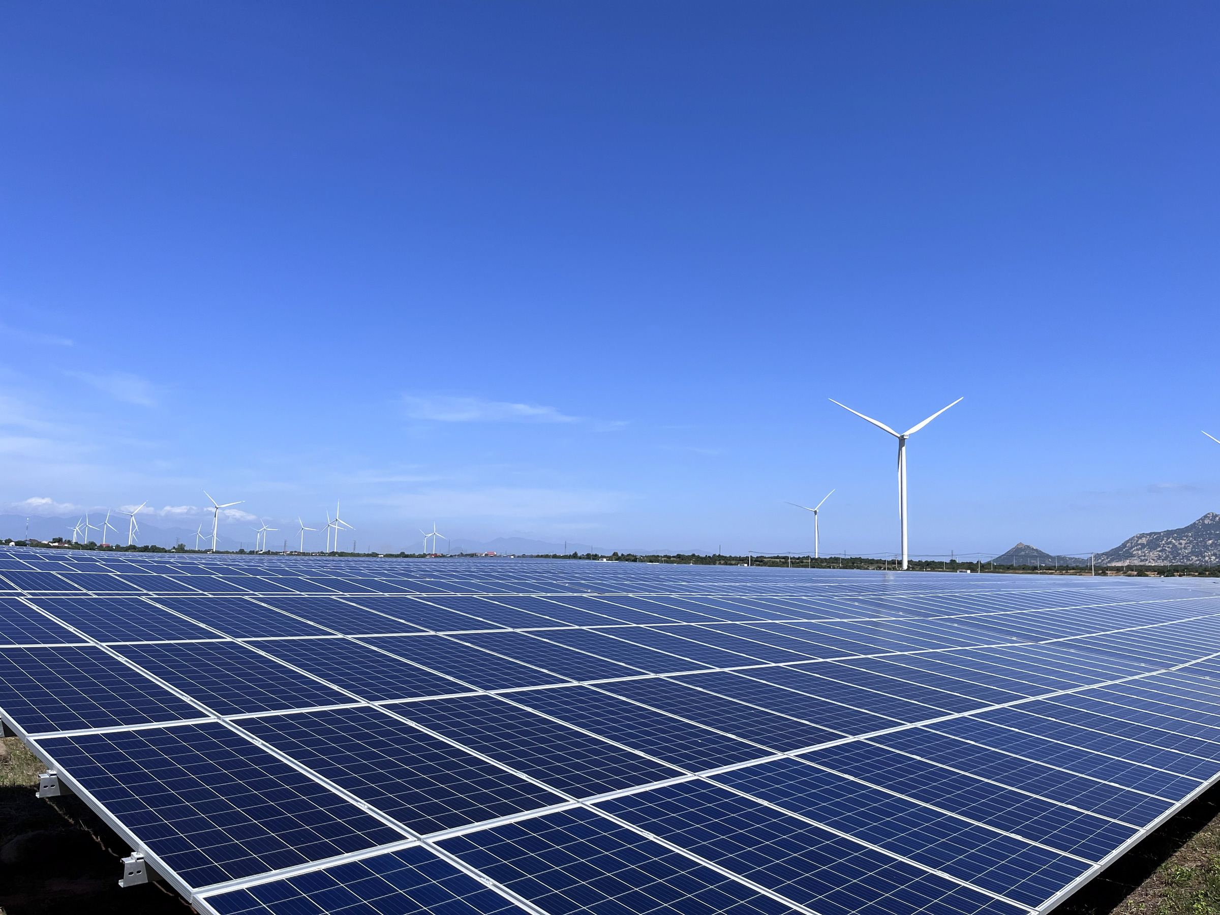 Solar plant with a wind turbine on the horizon